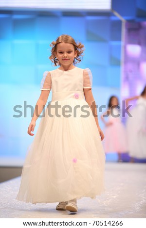 ZAGREB, CROATIA - FEBRUARY 4: Unidentified child Fashion model in bridesmaid dress on \'Wedding days\' show, February 4, 2011 in Zagreb, Croatia.