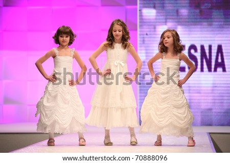 ZAGREB, CROATIA - FEBRUARY 4: Unidentified 6 year old children Fashion models in bridesmaid dresses on \'Wedding days\' fair, February 4, 2011 in Zagreb, Croatia.