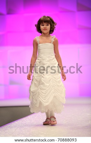 ZAGREB, CROATIA - FEBRUARY 4: Unidentified 6 year old Fashion model in bridesmaid dress on \'Wedding days\' fair, February 4, 2011 in Zagreb, Croatia.
