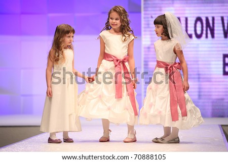 ZAGREB, CROATIA - FEBRUARY 4: Unidentified 6 year old children Fashion models in bridesmaid dresses on \'Wedding days\' fair, February 4, 2011 in Zagreb, Croatia.