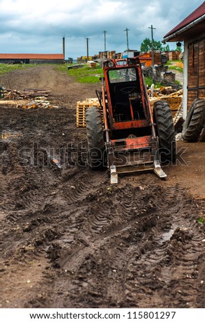 Red tractor in the mud outdoors