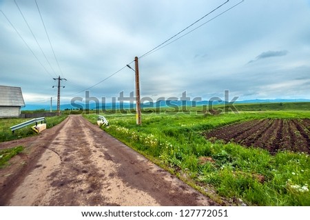 Rural road with blue sky and electric cables
