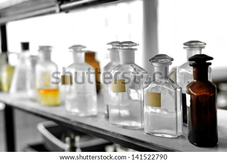 Photo of an old laboratory with a lot of bottles and dirt