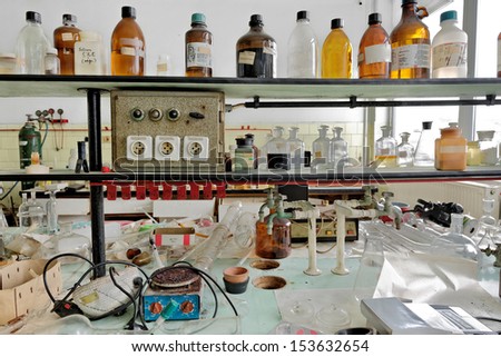 Photo of an old laboratory with a lot of bottles and dirt