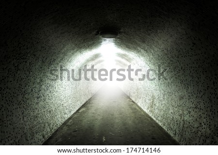Light at the end of a tunnel with tiled wall