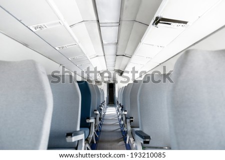 Interior of an airplane with many empty seats