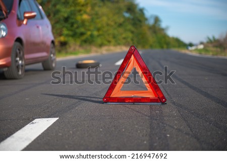 Red triangle of a car on the road