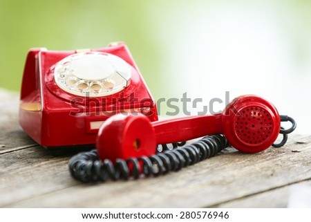 Old Fashioned Red phone on wooden deck