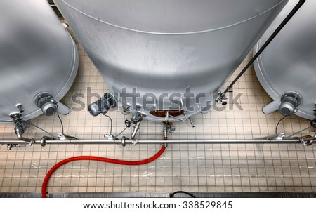 Large industrial white silos in modern factory interior