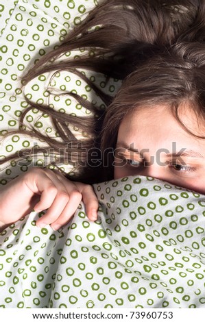 Girl scared of something under blanket