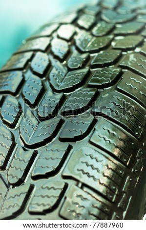 Wet car tire texture in green and blue colors