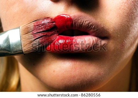 Conceptual makeup with a little bit of red paint
