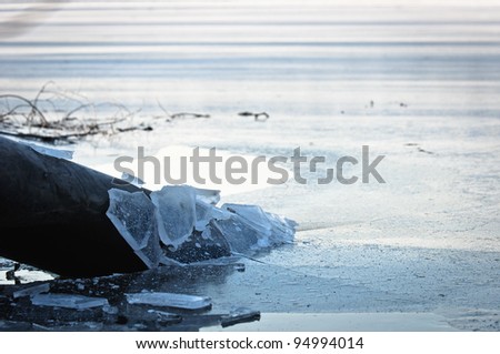Sewer pipe frozen into water at winter
