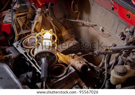 Industrial lamp on old motor block in a car