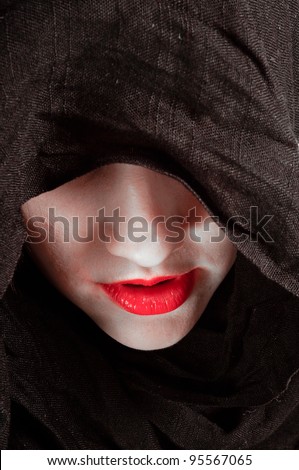 Conceptual photo of a woman in black hood