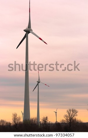Wind turbines against dusk