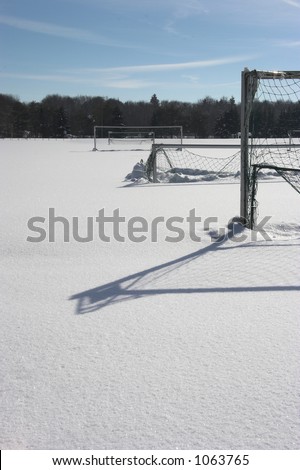 snow covered soccer-field with goals