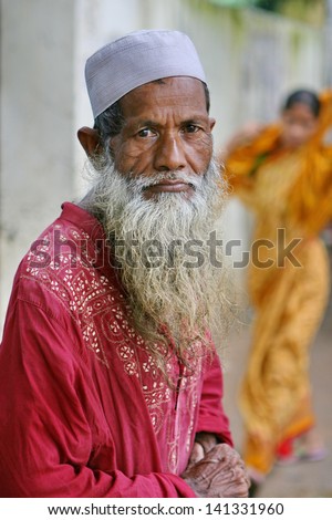 DHAKA, BANGLADESH - JULY 1: An old man wearing traditional Muslim clothes on a roadside on July 1, 2008 in Dhaka, Bangladesh.  Poverty makes old age even more of a challenge in developing nations.