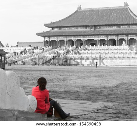 Woman gazes across a courtyard in the Forbidden City