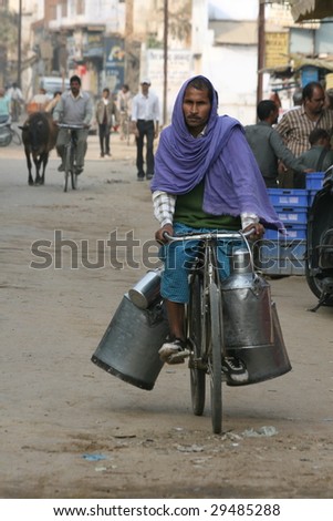 VARANASI, INDIA - NOVEMBER 27: A man delivers milk in unrefrigerated milk cans on November 27, 2008.  Unhygienic milk storage and distribution practices can lead to outbreaks of disease.