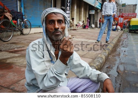 DELHI, INDIA - APRIL 17: An unidentified man smokes a traditional \