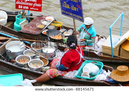 AMPHAWA, THAILAND - JUNE 19: Unidentified women sell food in a floating market in Amphawa, Thailand on June 19, 2011. Floating markets cater to tourism that contributes to 7% of the country\'s GDP.