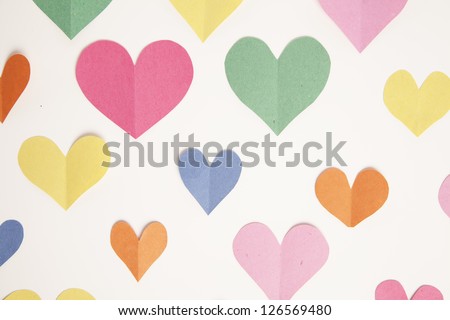 Cut out paper hearts from construction paper form a background.