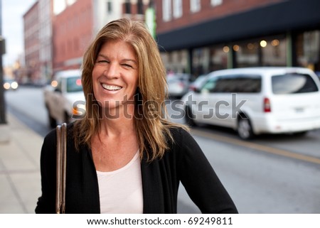 Attractive middle-aged woman downtown in the city.