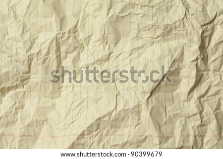 Crumpled yellow lined legal paper background.