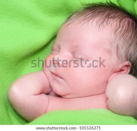 Sleeping Newborn One Week Baby Boy in a Green Blanket