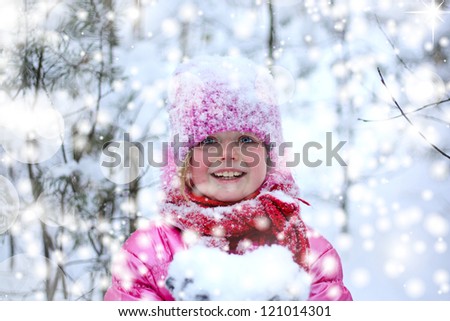 Little girl in snow forest.