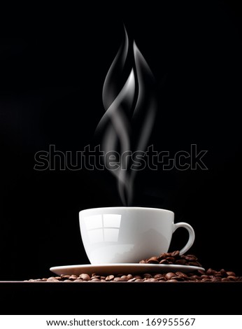 Coffee cup with smoke and grain against black wall.