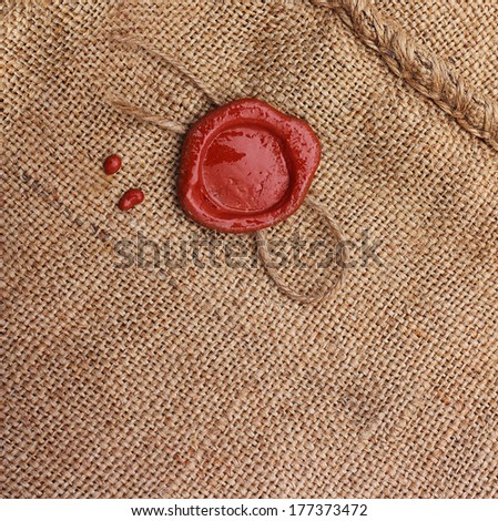 Burlap hessian sacking with wax seal stamp.