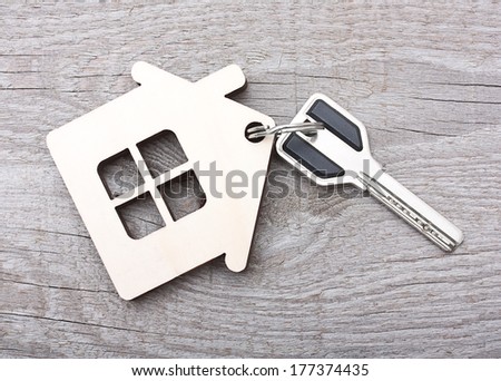 Key with house on wooden desk