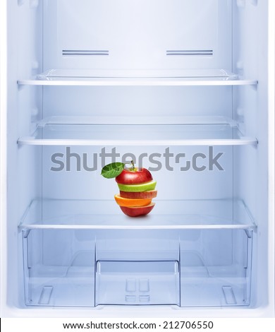 Healthy eating, diet concept. Apples and orange fruit in empty refrigerator.