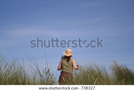 Woman on sand dunes looking up