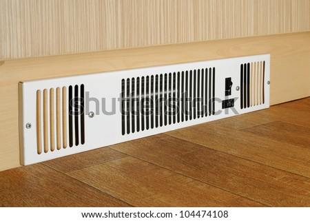 A floor level electric fan heater fitted into a kitchen kickboard