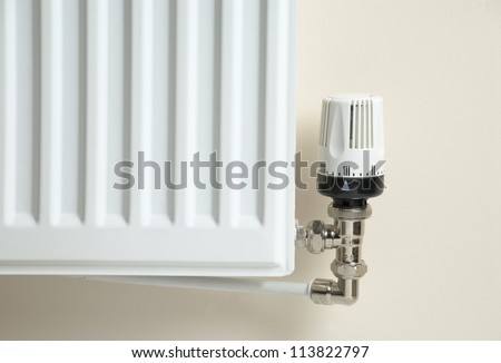 Corner of a domestic radiator, showing the temperature control valve