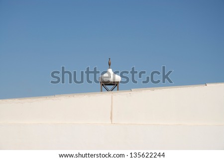 Detail of the roof on a Spanish villa against a clear blue sky