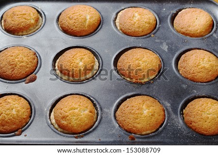 Fresh baked sweet buns on baking tray. Overhead view