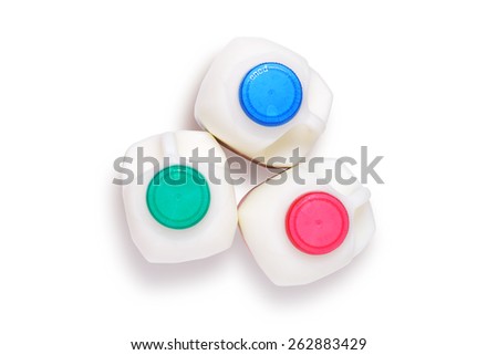 Three varieties of milk, in plastic bottles, skimmed,semi-skimmed and full-fat, shot from above isolated on white with clipping path
