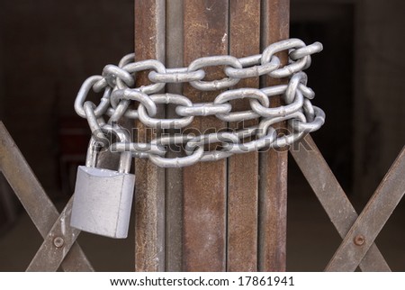Closeup of a metal gate chained and locked