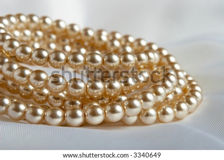 White pearls strings on a piece of silk
