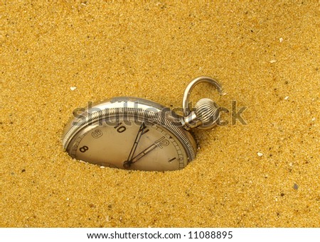 Vintage pocket watch  in the sand