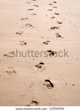 Man and womens footsteps in the sand