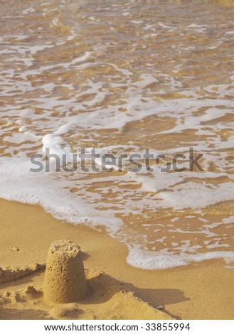 Sandcastle on the beach by the sea