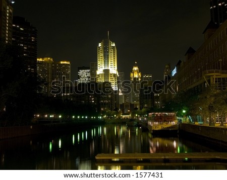 standing by Chicago River at night