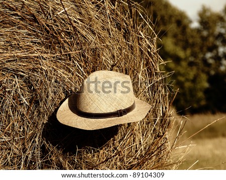 Autumn - straw hat on straw bales