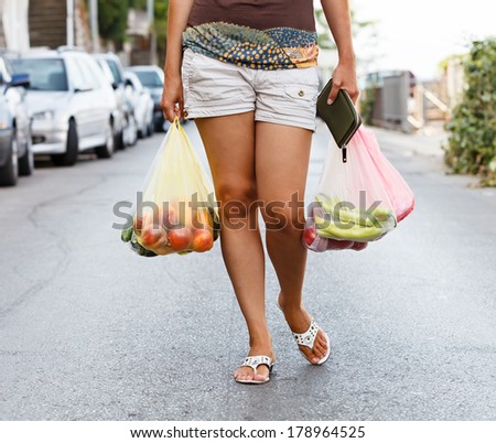 girl hands bag with fresh vegetables