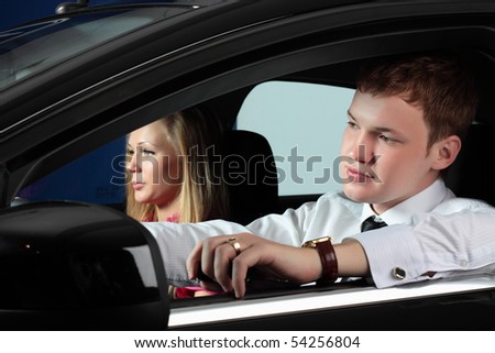 young businessman and charming woman in the car